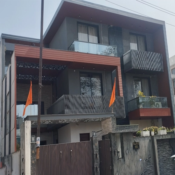 Modern building with balconies and decorative details by Nirmaan Groups.